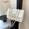 Quilted white shoulder bag with golden chain strap and unique U-shaped metal buckle - White
