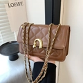 Quilted brown leather chain shoulder bag with elegant gold-tone hardware and U-shaped clasp - Brown