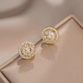 Sparkling sunflower stud earrings with rotating cubic zirconia on a jewelry box - Rotating Earrings / Gold Color (E0393)
