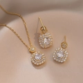 Dettaglio del set di gioielli in zircone verde smeraldo su sfondo in tessuto di seta champagne - Set di Gioielli di Zircone (Collana + Orecchini) / Bianco Zircone