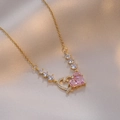 Pink heart zircon pendant necklace in gold finish on elegant beige silk background - Gold