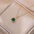 Elegant emerald green zircon necklace in gold plating displayed in a luxury jewelry box - Gold Emerald Necklace
