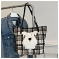 Detail of checkered tweed tote bag with a white fluffy dog patch on metal hanger - Black Lattice
