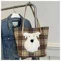 Close-up of brown plaid tote bag featuring a cute white schnauzer embroidery patch - Plaid Khaki
