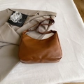 Minimalistische braune Halbmond-Umhängetasche aus Kunstleder mit schmalem Gurt - Braun