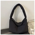 Detail of black quilted shoulder tote bag with wide padded strap and metallic zipper - Black