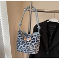 Detail of blue leopard plush tote featuring puppy embroidery and knotted leather handle - Blue