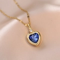 Macro shot of a heart-shaped blue gemstone pendant on a gold chain over champagne satin - Blue Zircon Style