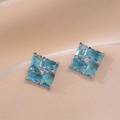 Elegant silver pin earrings with emerald-cut blue stones arranged in a pinwheel shape - Blue Zircon Earrings (E495)
