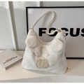 Detail of white plush pig-shaped handbag featuring unique textures and leather strap - Off White