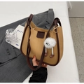 Detail of contrast stitch handbag in khaki PU leather with brown trim and plush charm - With Charm / Khaki