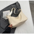 Chic beige lychee grain leather crescent bag with wide shoulder strap and gold hardware - White