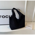Detailed view of the black pleated bubble fabric and large capacity hobo tote design - Black