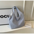 Detail of light blue textured fabric tote bag showing hobo style and woven pattern - Blue