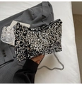 Detailed macro of sparkling silver sequins and metal chain on a stylish handbag - Silver
