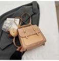 Beige vintage backpack with flap closure and cute plush charm on white surface - With Charm / Khaki