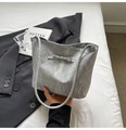 Silver-grey wrinkled fabric bucket bag with bow detail on a minimal background - Silver