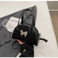 Detail of black bowling bag featuring a metallic butterfly and suede leather patchwork - Black