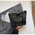 Glossy black patent leather bucket bag with bow detail and slender shoulder strap - Black