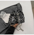 Detail of silver sequins on a black bucket bag with pearl drawstring and metal chain - Silver