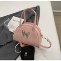 Pink suede saddle bowling bag with silver butterfly charm and adjustable crossbody strap - Pink
