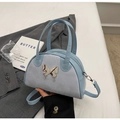 Light blue bowling shoulder bag featuring suede patchwork and metallic butterfly charm - Blue