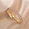 Close-up of golden bracelet featuring marquise-cut pink cubic zirconia on silk background - Gold with Amber Gems (B00432-14)