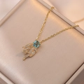 Elegant gold necklace with square blue stone and crystal-encrusted feather pendants - Colorful Flame Necklace (X2260)