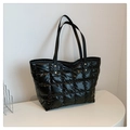 Detail of black quilted tote bag with gold rivets and spacious nylon material - Black
