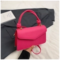 Detail of magenta woven texture handbag with knotted handle and golden metal buckle - Pink