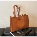 Minimalist large brown leather tote bag with double handles on artistic book base - Brown