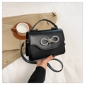 Black PU leather small crossbody bag featuring a sparkling silver rhinestone bow clasp - Black