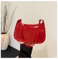 Detail of red patent leather hobo bag featuring glossy finish and gold zipper closure - Red