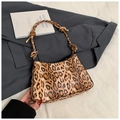 Detail of leopard print hobo bag with knotted shoulder strap and golden metal hardware - Brown