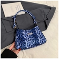 Detail of blue leopard print velvet shoulder bag with a knotted handle and gold metal trim - Blue
