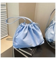 Light blue pleated drawstring bucket tote bag with silver bow detail and dual handles - Blue