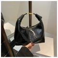 Detail of glossy patent leather texture with embossed maisone logo and gold hardware - Black