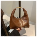 Close-up of brown glossy synthetic leather hobo bag with embossed maisone lettering - Brown