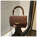 Close-up of geometric quilted dark brown crossbody bag with pleated handle and gold hardware - Brown