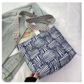 Close-up of geometric blue striped canvas tote bag with floral print wide shoulder strap - Blue