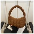 Detail of caramel quilted hobo bag featuring unique bubble twist handle design - Brown