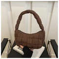 Detailed shot of dark brown quilted suede-textured handbag with a secure top zipper - Brown