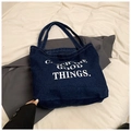 Close-up of durable dark blue denim tote bag with white Catch The Good Things print - Dark Blue