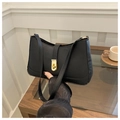 Close-up of minimalist black underarm bag with elegant gold twist-lock metal buckle detail - Black