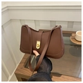 Detail of a dark brown crescent underarm bag featuring a vintage gold twist-lock closure - Brown