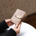 Close-up of small faux leather wallet featuring a forest mushroom print and metal hardware - Apricot