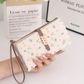 Close-up of PU leather long wallet with floral patterns and gold leaf metal buckle - Beige Apricot