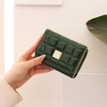 Detail of dark green quilted mini wallet with gold buckle and smooth side zipper - Green