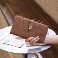 Close-up of brown frosted leather wallet with zipper, wrist strap and gold logo - Coffee