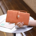 Orange long PU leather wallet with 'Z' buckle and wristlet strap shown in hand - Orange